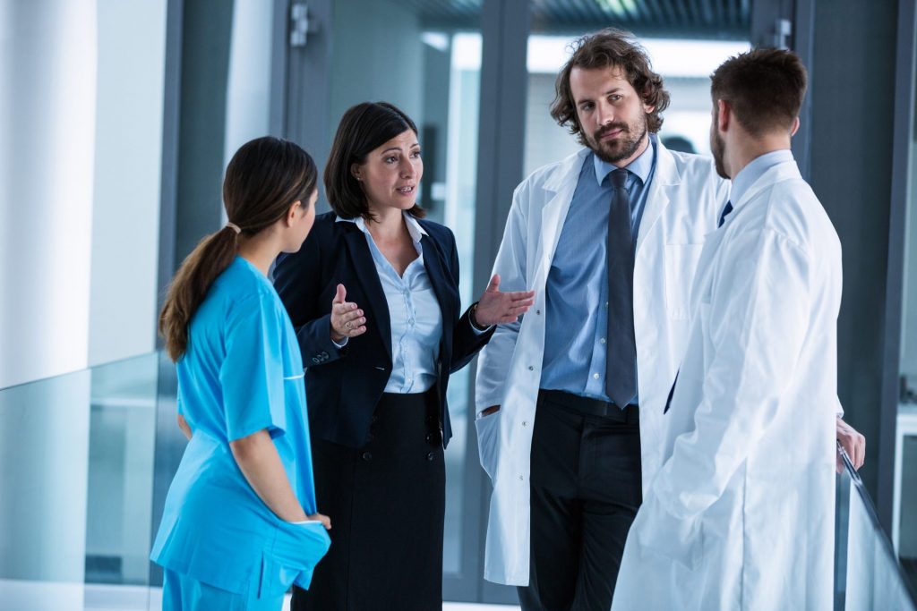 a group of doctors conversing in the hallway